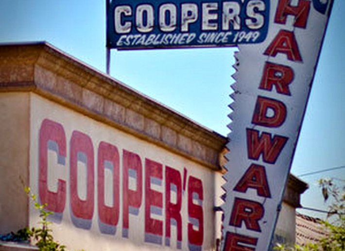 The facade of Cooper's Hardware with a saw-shaped sign