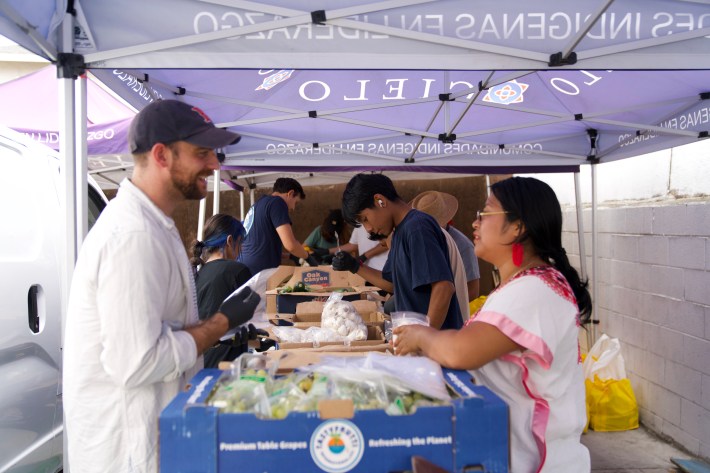 CIELO volunteers building boxes full of culturally meaningful food. Photo by Biani Martinez for L.A. TACO.
