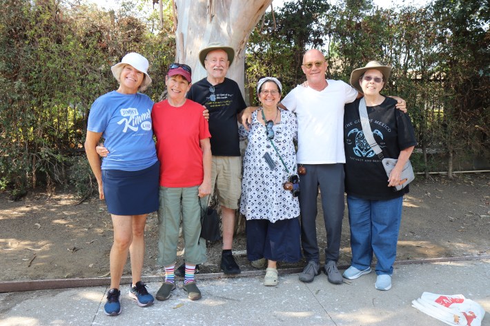 A group of San Fernando Valley residents who come together to spread awareness over freeway overpasses in Los Angeles pose for a photo after packing up their signs.