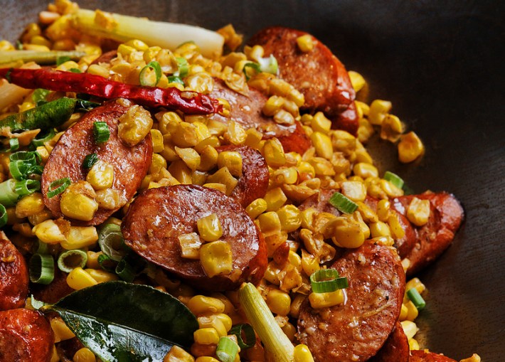 A dish of smoked sausage and corn mixed together