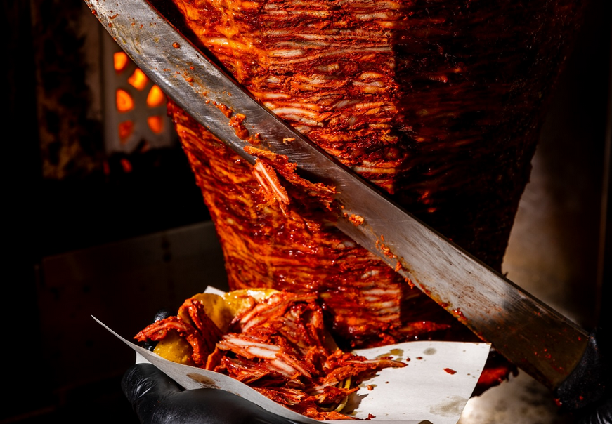 al pastor being sliced