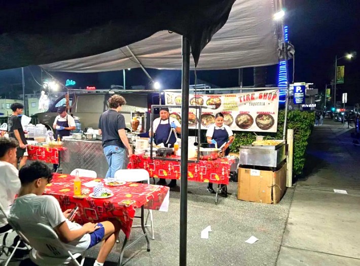 A taco stand in Hollywood with red tablecloths