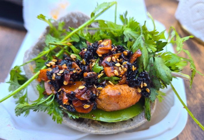 Camello's labneh chicken thigh al pastor in a blue corn pita, with herbs and salsa macha