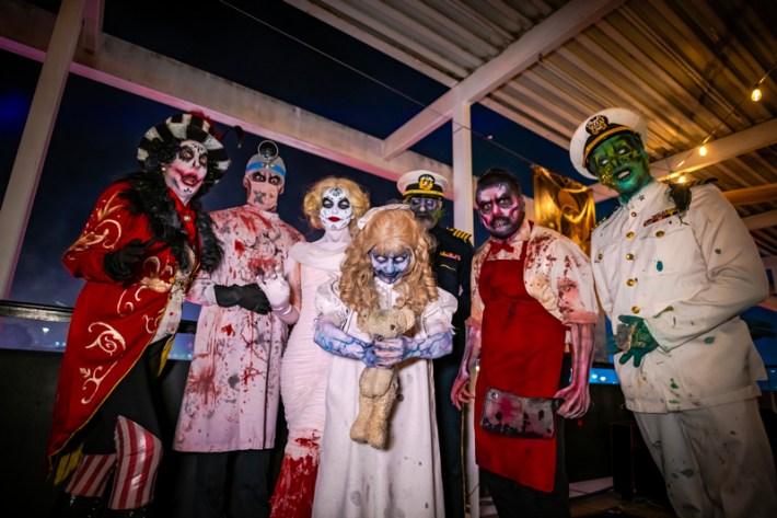 Cast members of Dark Harbor, dressed as maritime-themed monsters, standing in a row