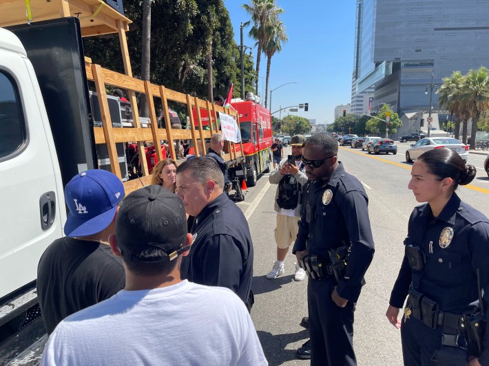 Protesters talk with police in front of City Hall.