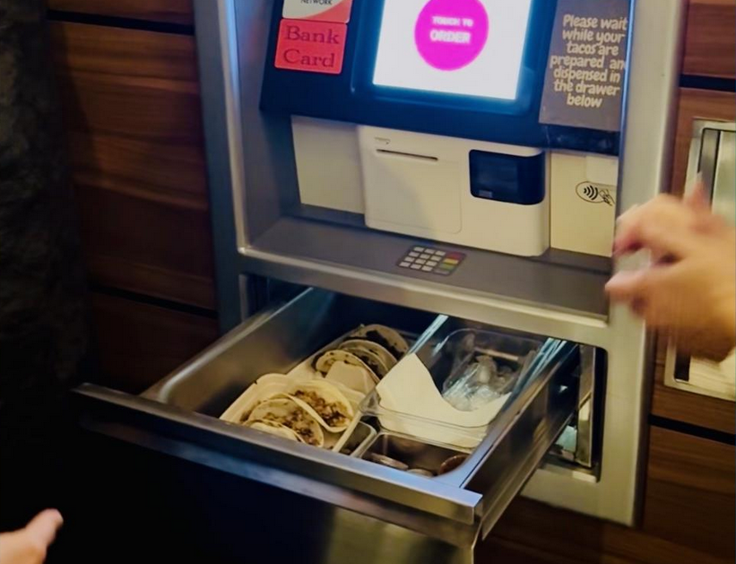 An ATM with tacos coming in a drawer in the bottom