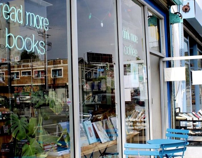 A bookstore window with books visible through the glass