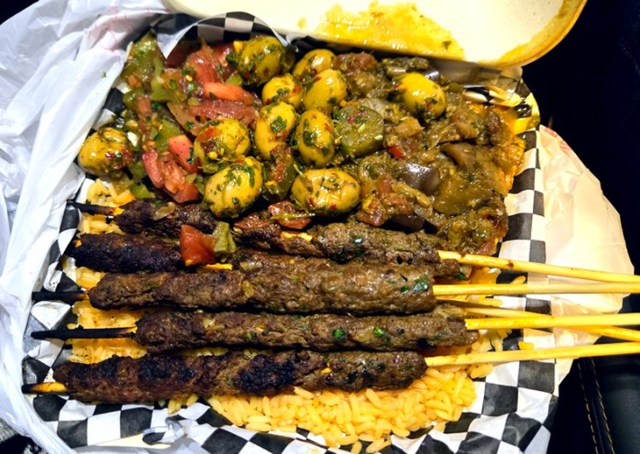 Lamb kebabs and olive-laced zaalouk on a checkerboard-patterned paper