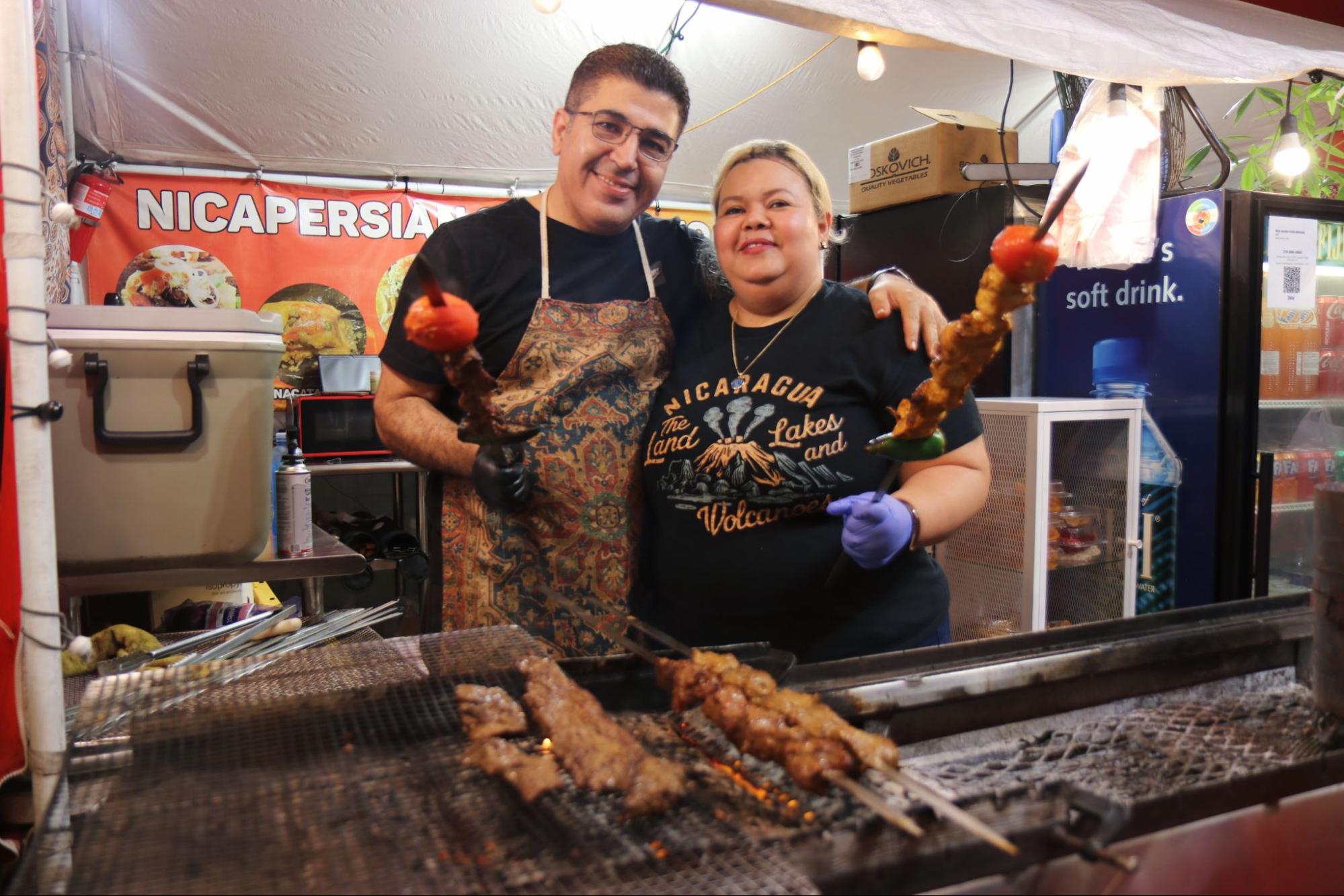 Ziomara Quintero and her husband, Reza Saadati, in front of their stand in South Central Los Angeles. Photo by Janette Villafana.