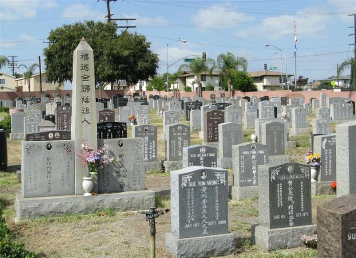 Many gravestones are seen with Chinese characters on them.