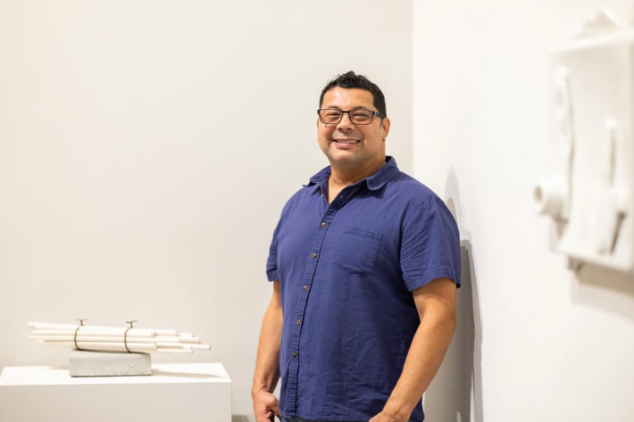 A man in a blue shirt smiles