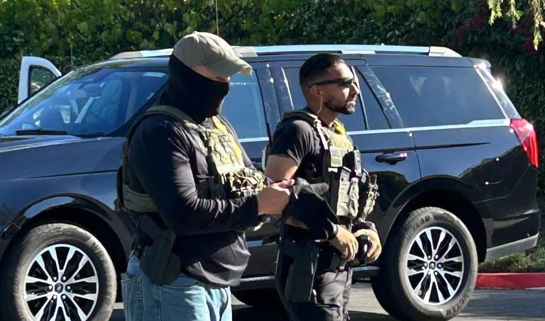 Two agents, one masked, transferring newly abducted day laborers in San Marcos, screenshot from Alianza Comunitaria