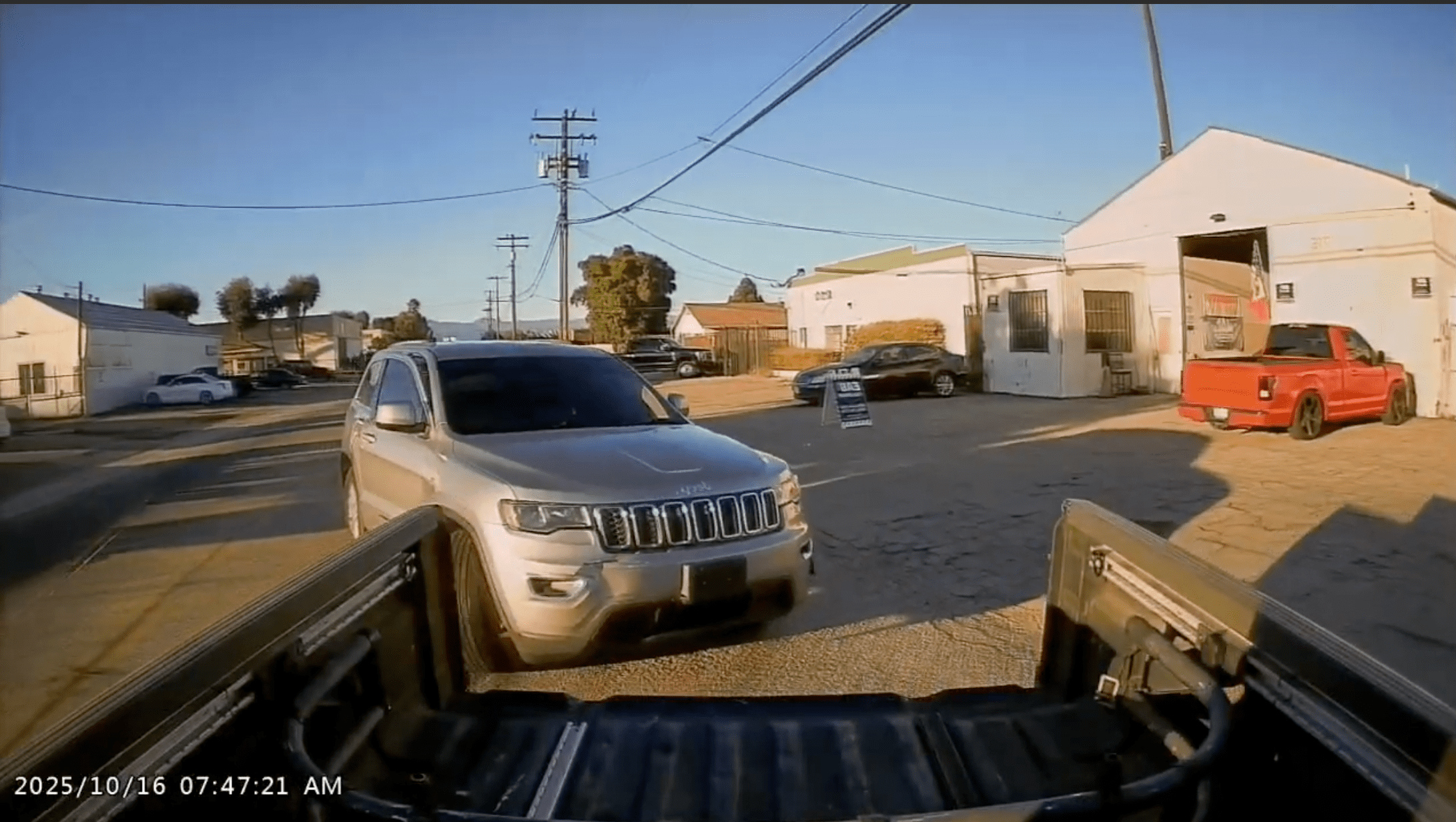 A silver Jeep is damaged in its front