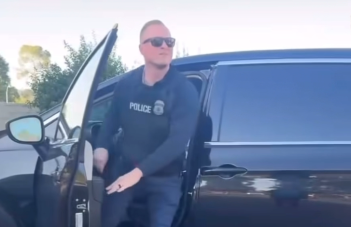 a police agent exits his vehicle