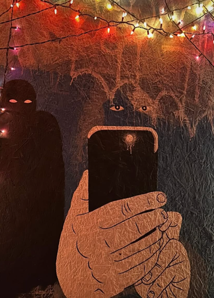 A large piece of artwork shows a hand holding a phone taking a photo, and the subject is hidden in the dark save for its eyes.