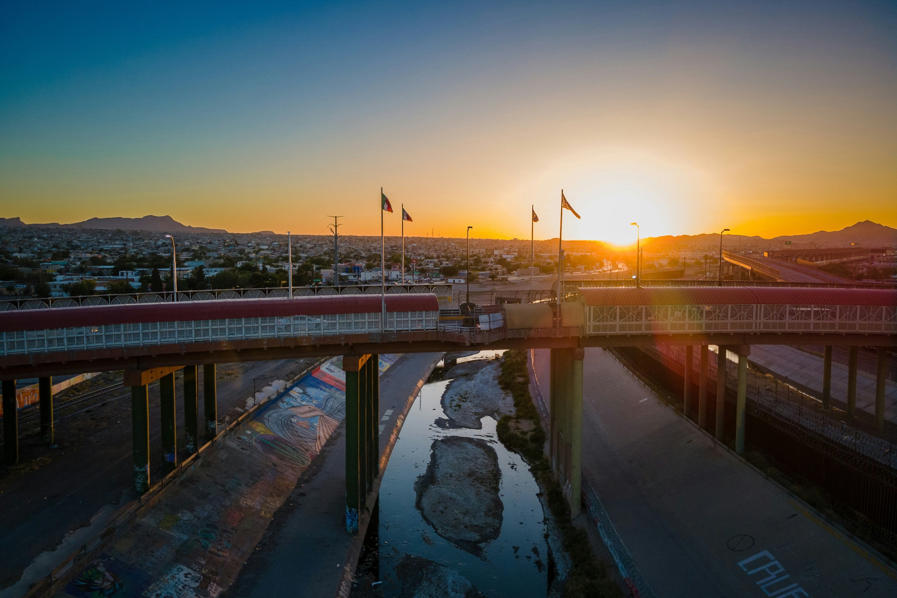 A view of the sun rising over a bridge separating El Paso from Juarez, Mexico.