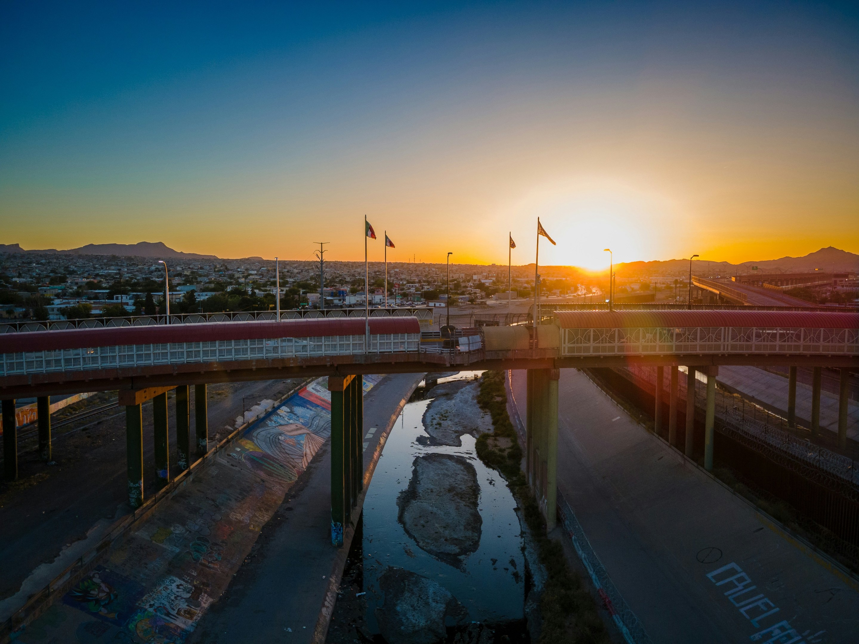 A view of the sun rising over a bridge separating El Paso from Juarez, Mexico.
