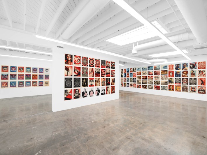 multiple walls covered in rows of art