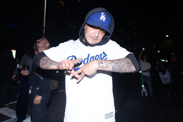 A man creates an LA logo with his hands