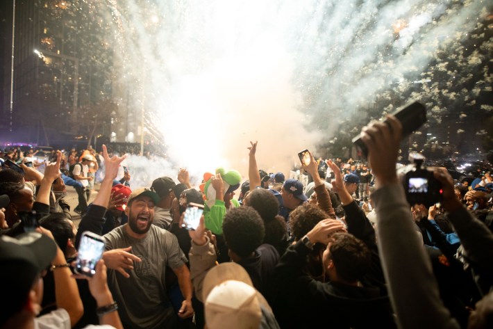 A crowd celebrates as a firework goes off