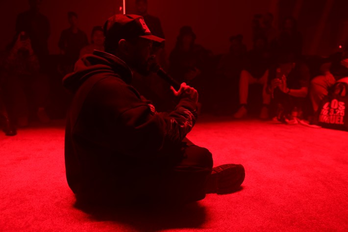 a man sits in the center of a circle of people