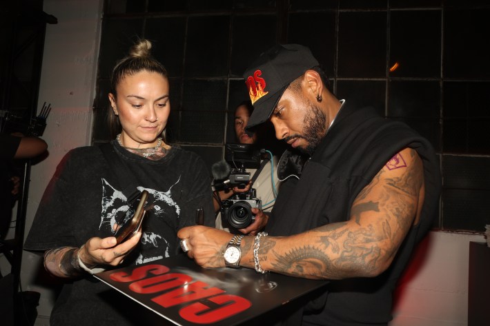 a man signs a vinyl for a fan