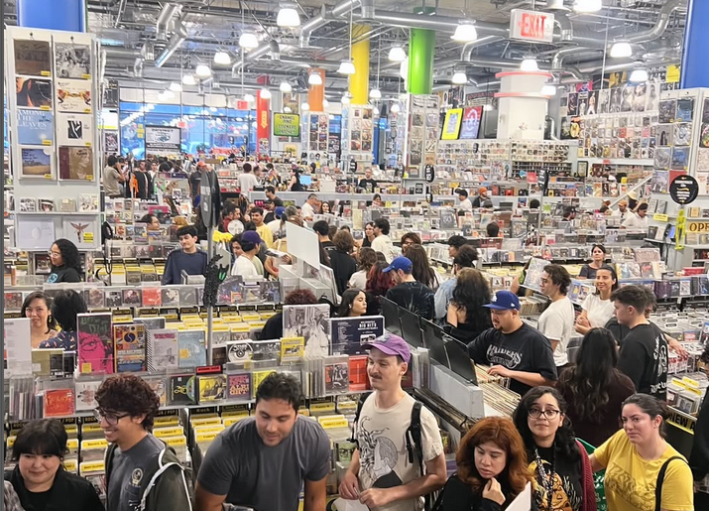 a large building packed with patrons browsing music records and merchandise