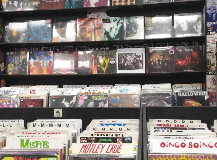 records on sale being displayed on the wall and within shelves