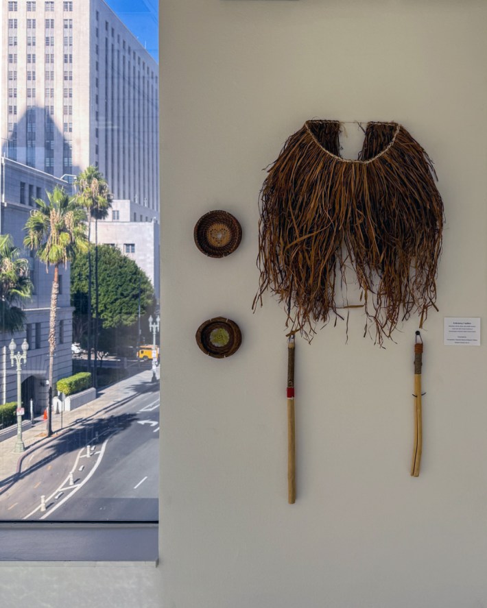 three pieces of art on the wall related to Indigenous culture