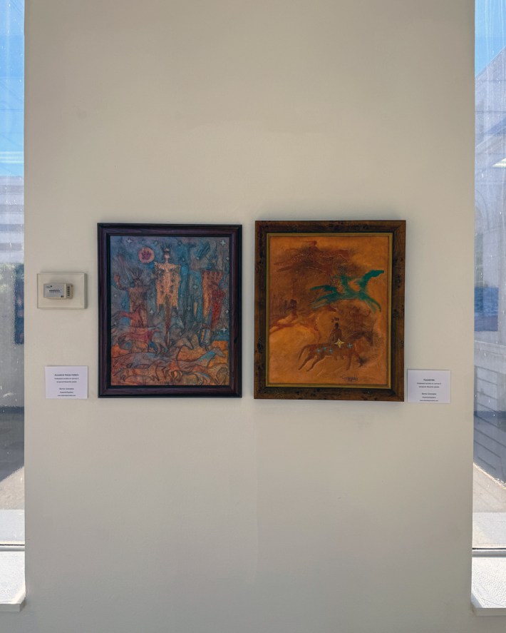 two pieces of art hanging on a wall