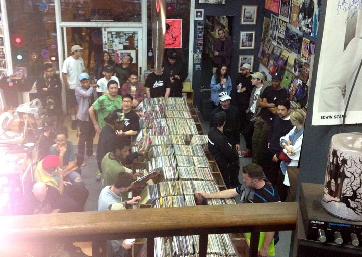 a shot from the second floor shows patrons on the first floor browsing loads of records