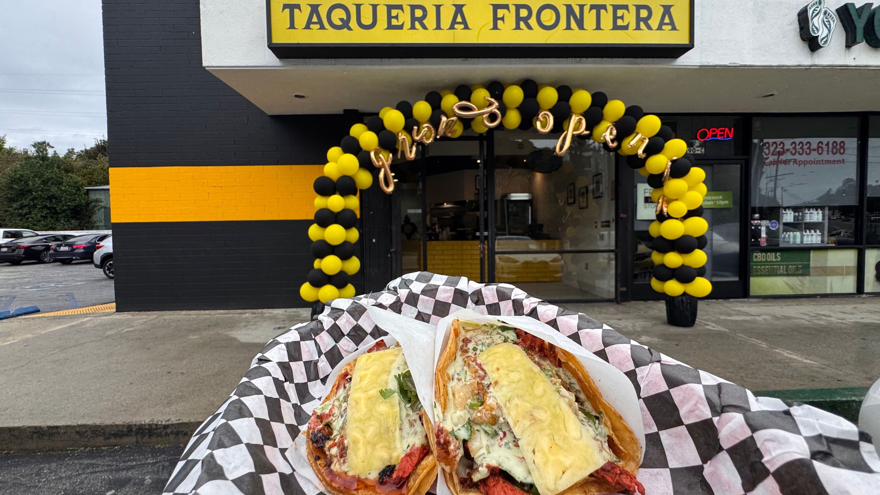 a restaurant "Taqueria Fronteria" with tacos also in the image