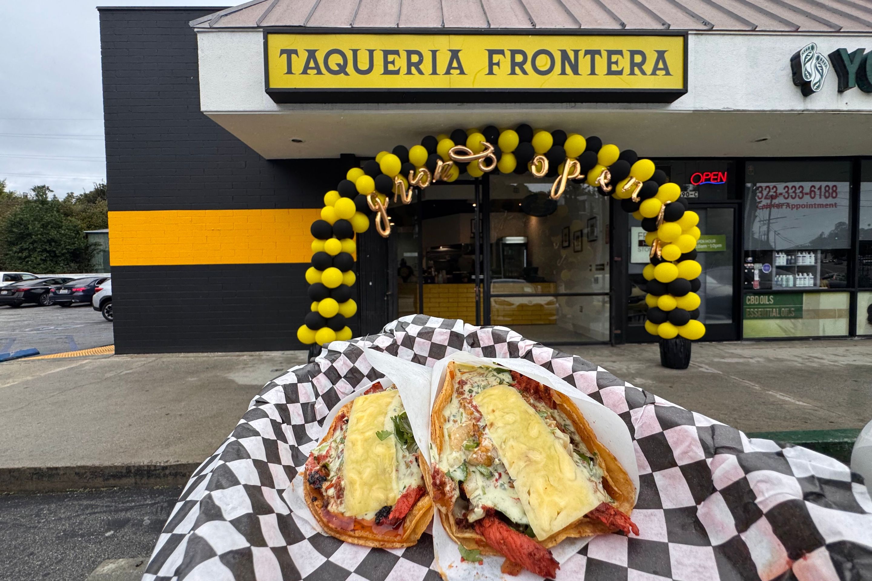 a restaurant "Taqueria Fronteria" with tacos also in the image