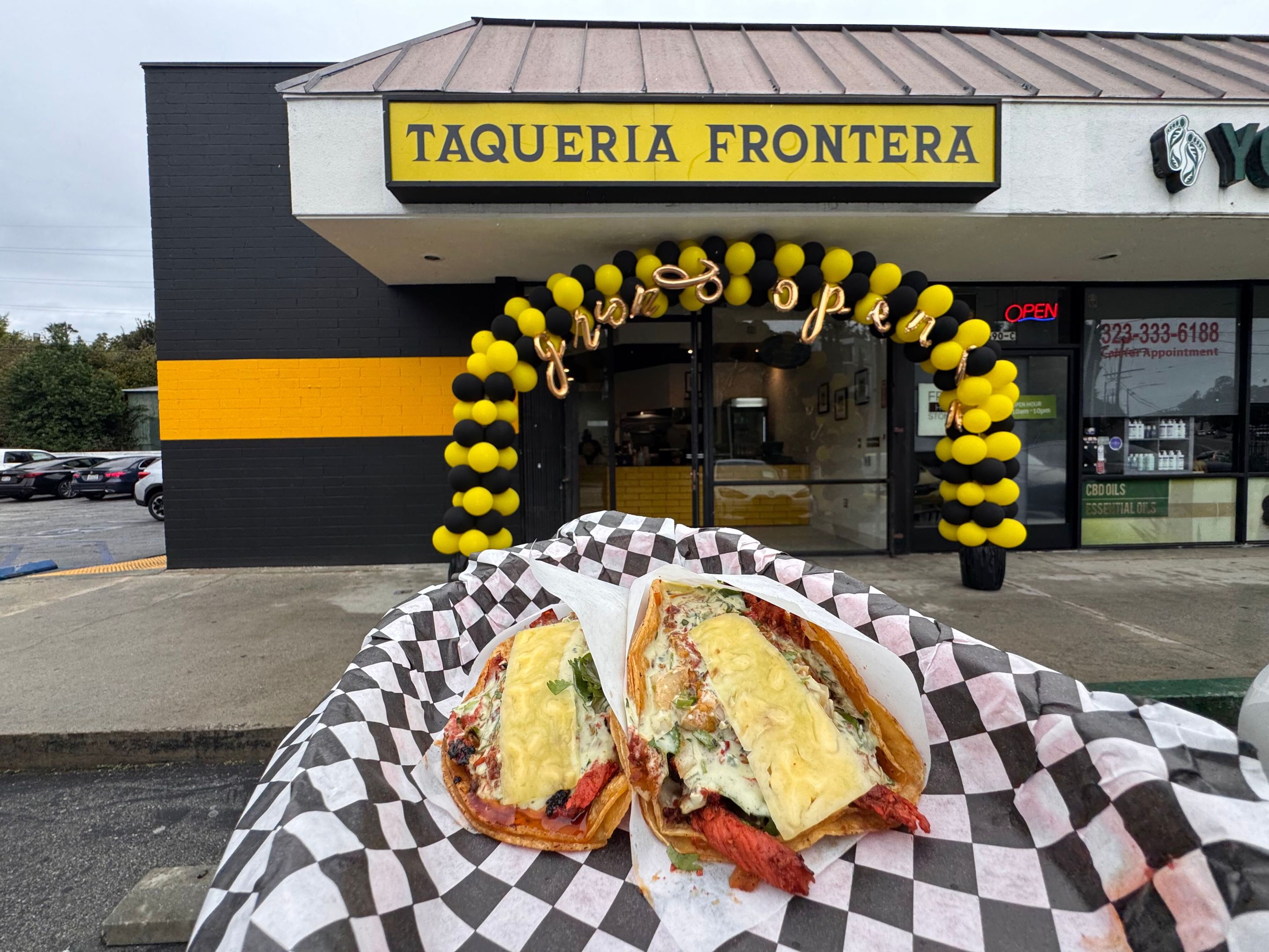 a restaurant "Taqueria Fronteria" with tacos also in the image