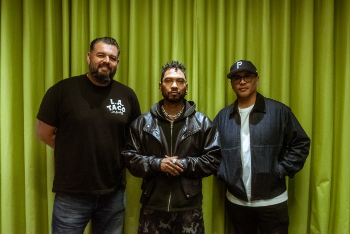 three men pose together