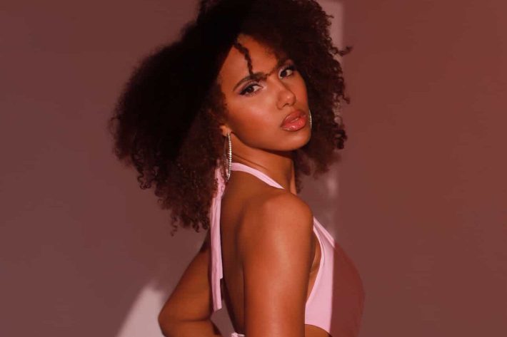 a woman in a pink two-piece poses