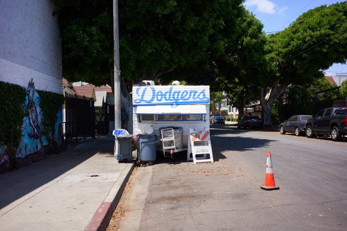 a street sign with the Dodgers logo