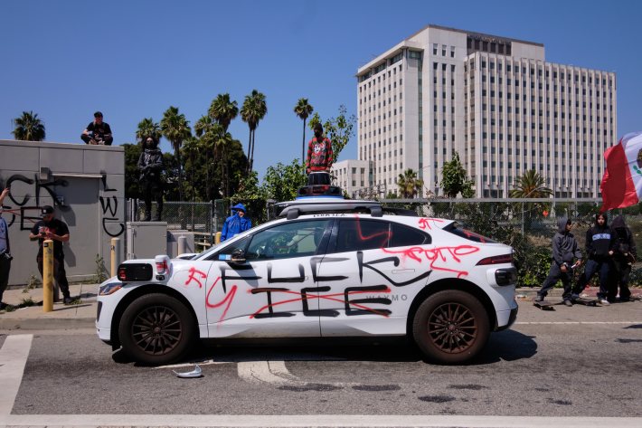 a car with "FUCK ICE" graffiti