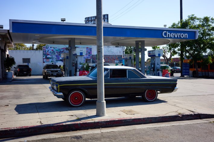a vintage car at a Chevron gas station