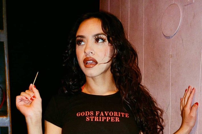 a woman in a crop top and skirt