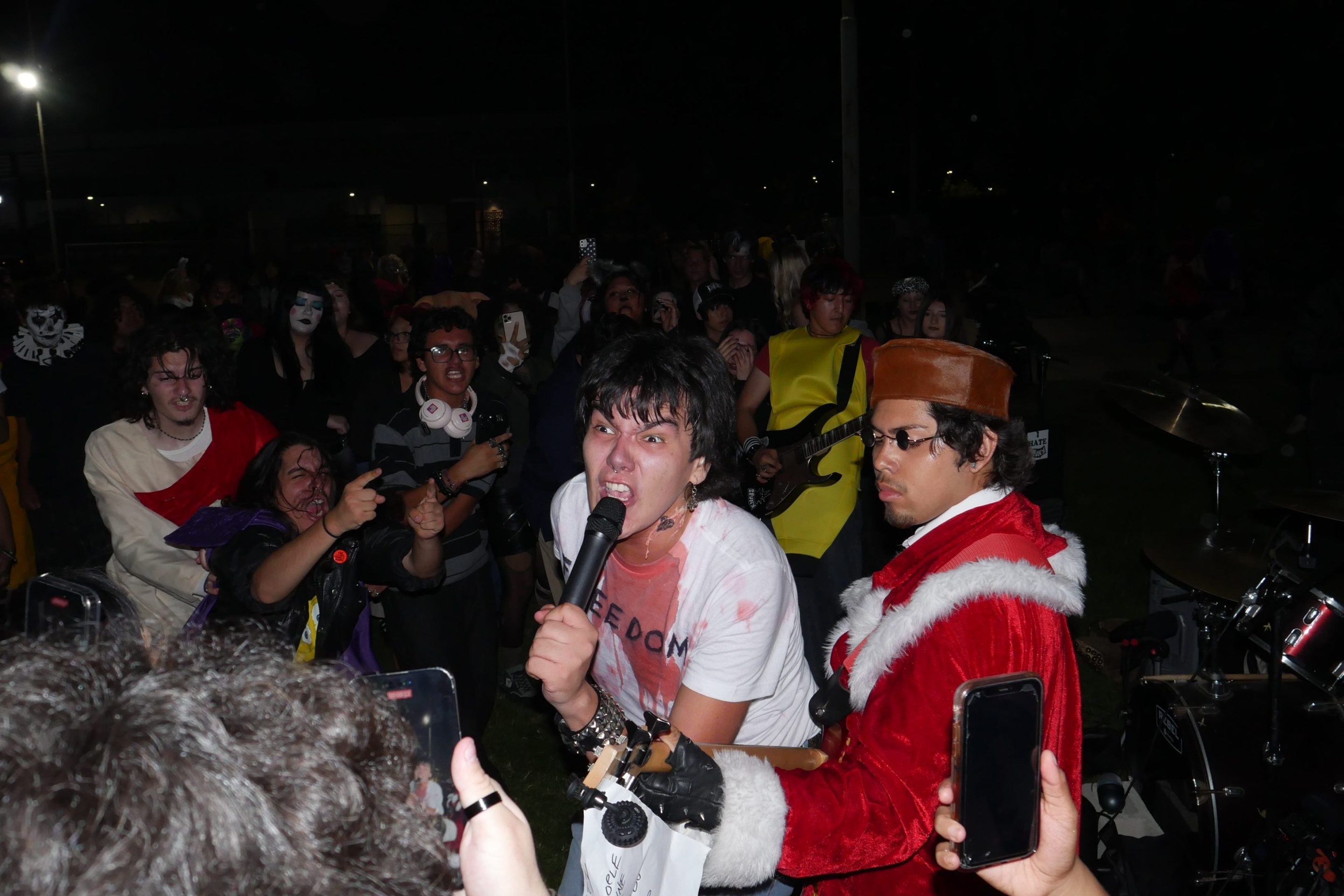 a young man viciously sings into a microphone