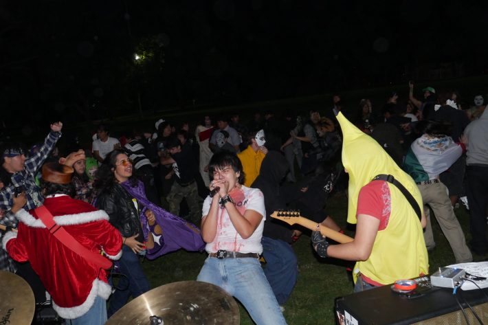 young men sing and play instruments together