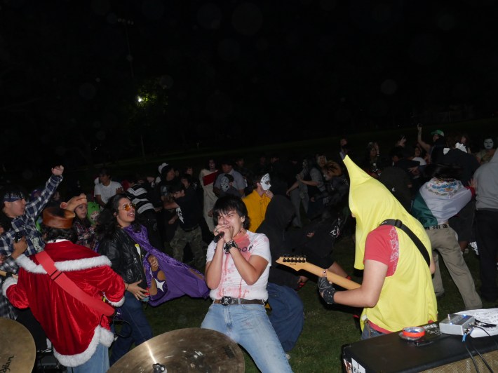 young men sing and play instruments together