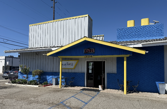 the exterior of a small blue building