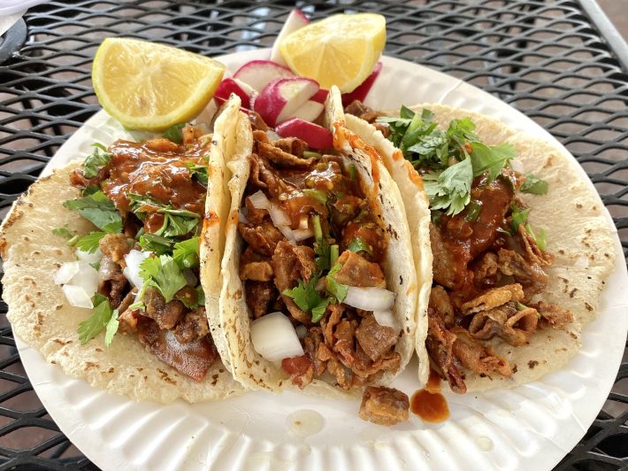 a plate of tacos on a to-go plate
