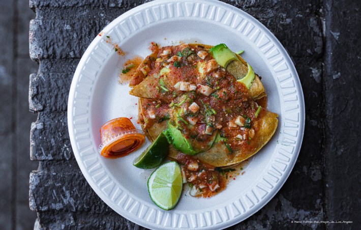 taco de camaron dorado on a to-go plate with salsa and lime on the side