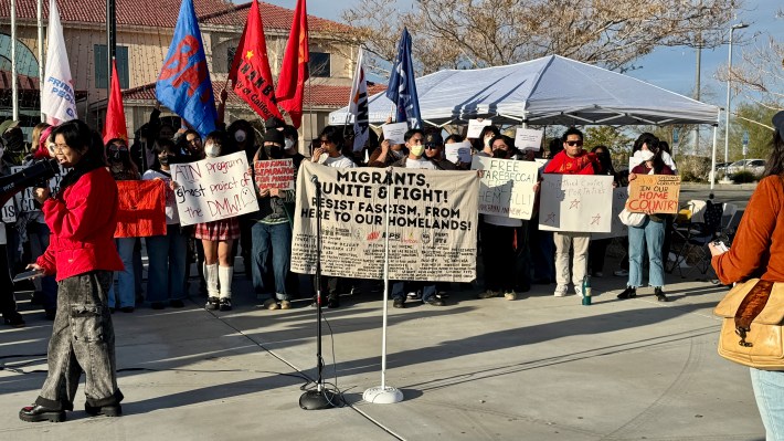 Rally attendees holding up signs