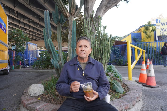 With a pair of earplugs hanging from his neck, Jose De La Torre sits in the Cypress Park Home Depot parking lot. Photo by Aisha Wallace-Palomares for L.A. TACO.