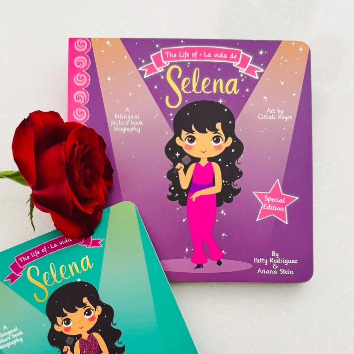 two kids' books on Selena next to a rose flower