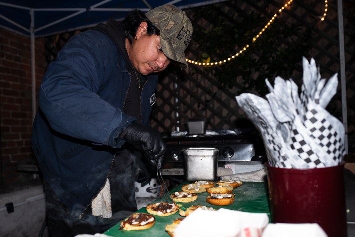 a man prepares a burger